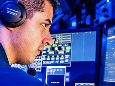 homeland security professional looking at computer monitors
