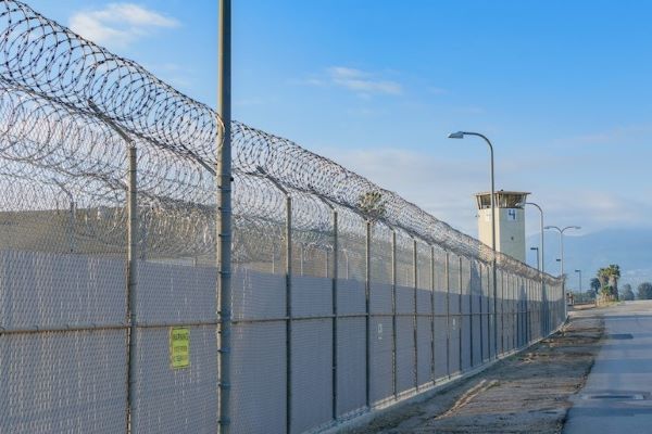 exterior of prison fence with barbed wire