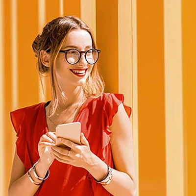 Woman smiling and holding phone in hands