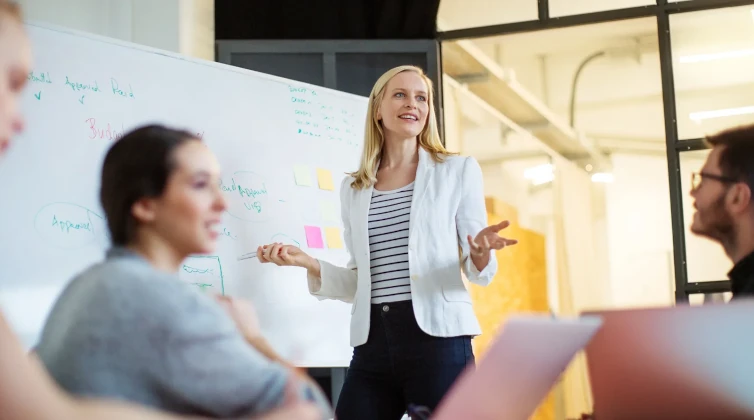 Woman presenting to students in a classroom