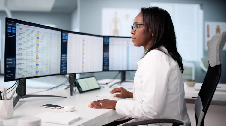 Woman looking at computer screens