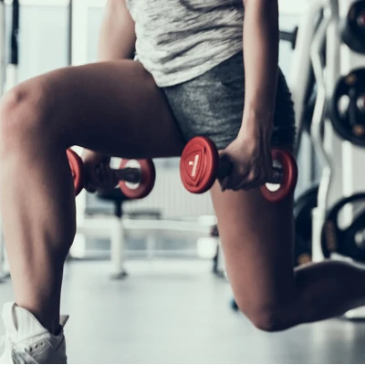 Woman lunging with weights
