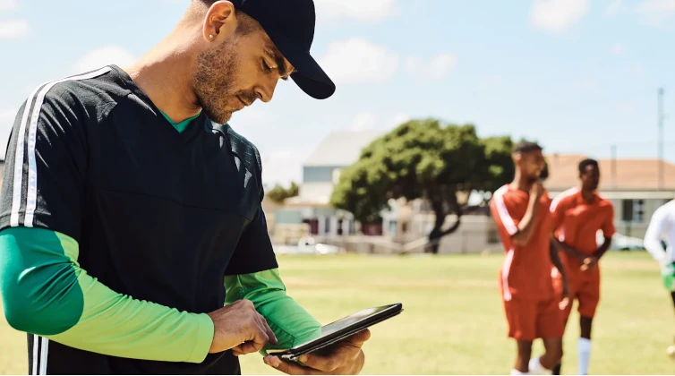 Sports coach looking at tablet