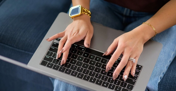 Woman typing on laptop