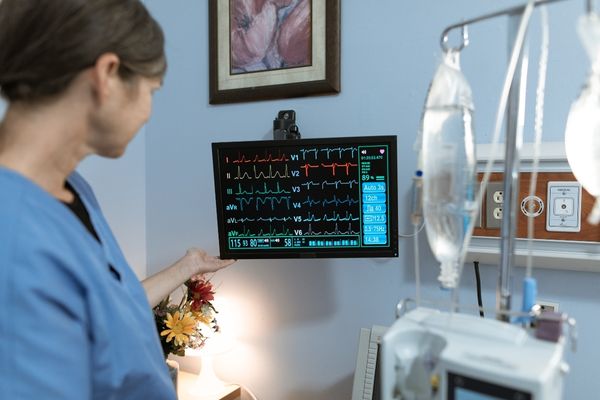 registered nurse looking at patient's vitals