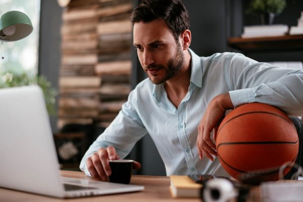 sports management professional holding basketball