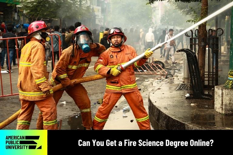 fire science students practicing with fire hose