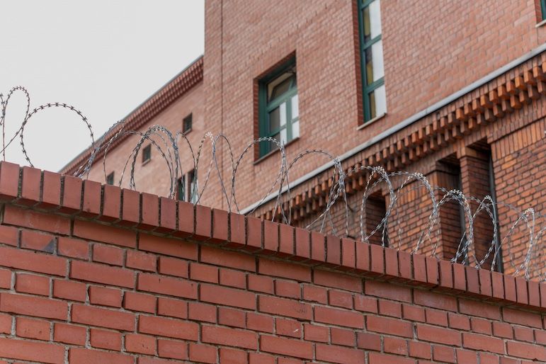 prison wall with barbed wire