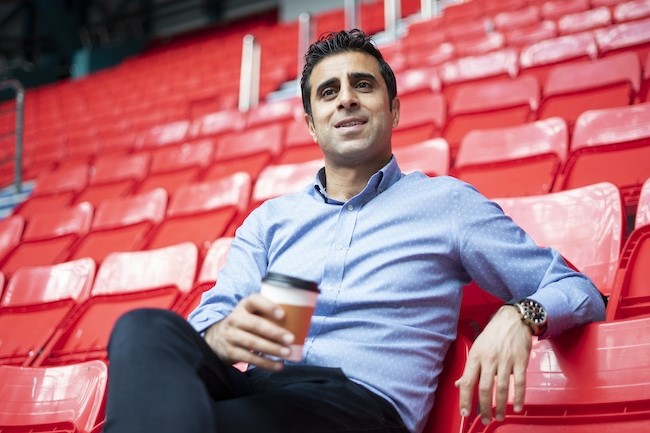 sports agent sitting in bleachers