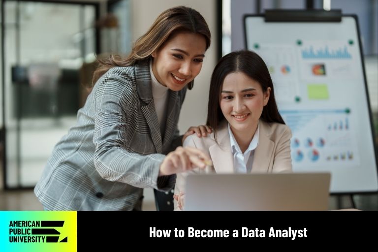 data analysts looking at data on laptop