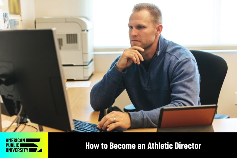 how-to-become-an-athletic-director athletic director looking at computer