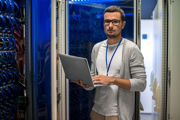 IT manager standing near servers