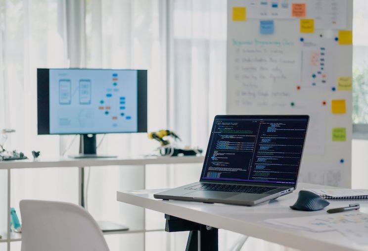 computer monitors displaying information technology coding