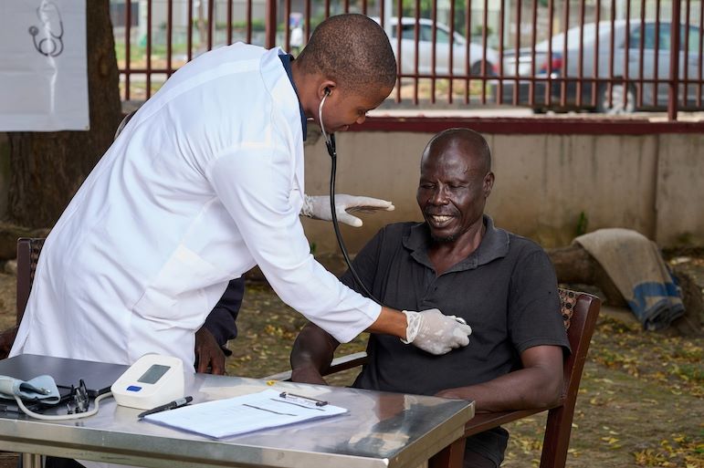 MPH professional examining patient