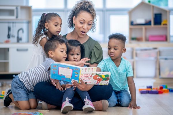 Early Childhood Education degree graduate reading to children