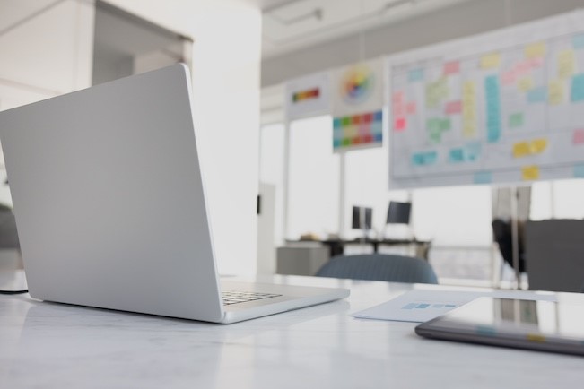 project manager office with laptop and whiteboard