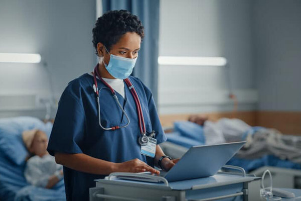 nurse typing on computer